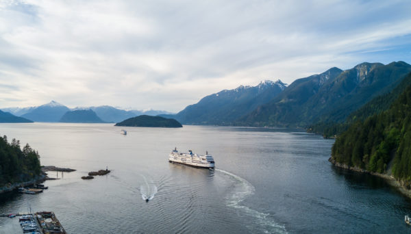 the commute and Aerial Panoramic view of Horseshoe Bay with Ferry leaving the terminal. Taken in Howe Sound, West Vancouver, British Columbia, Canada.