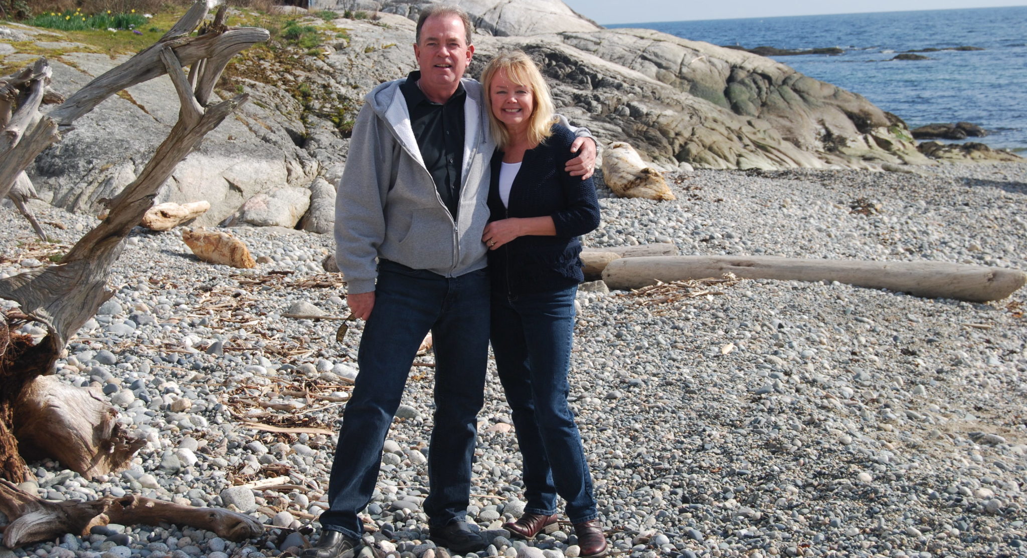 couple on beach who have downsize